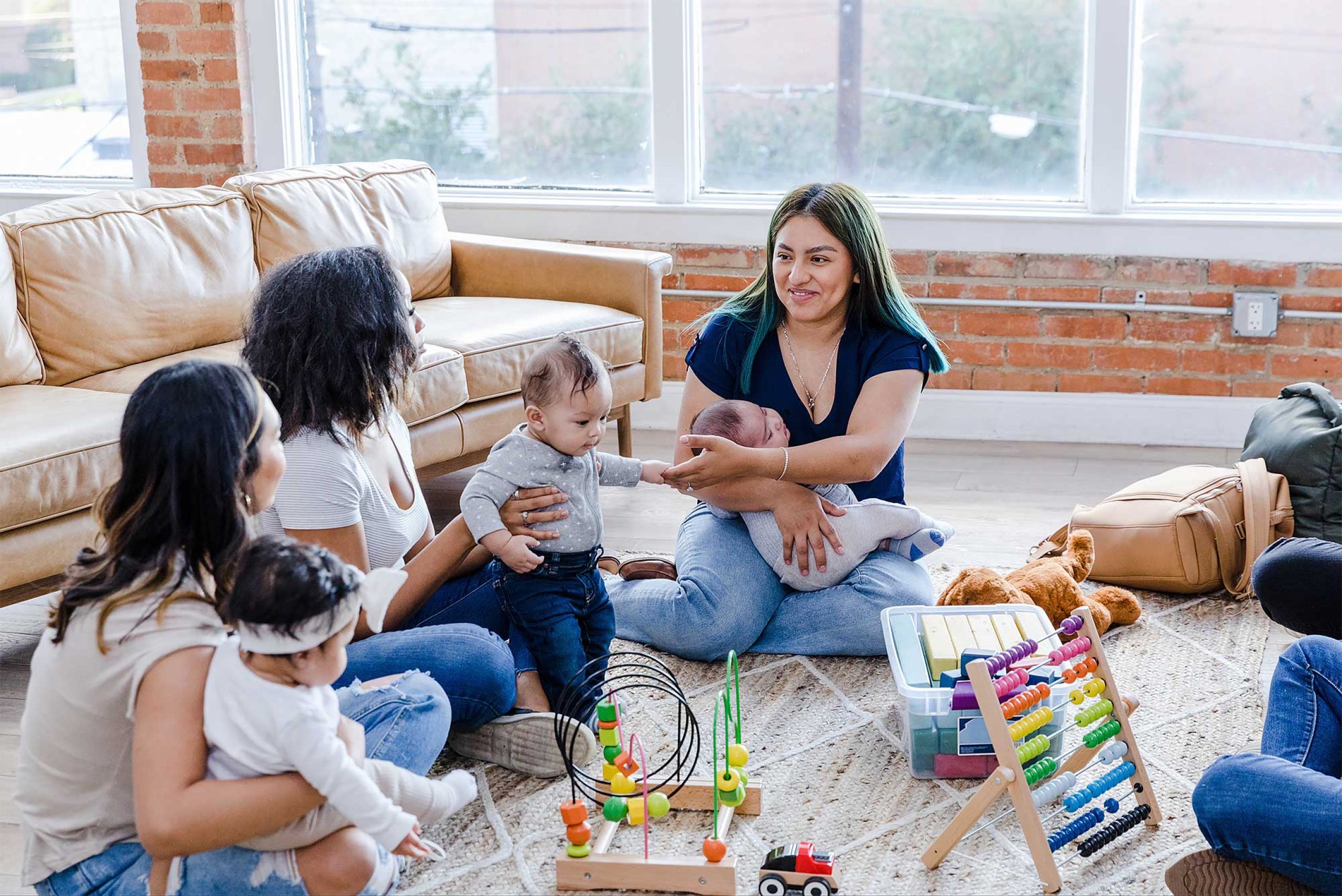 Mothers holding their babies in a room
