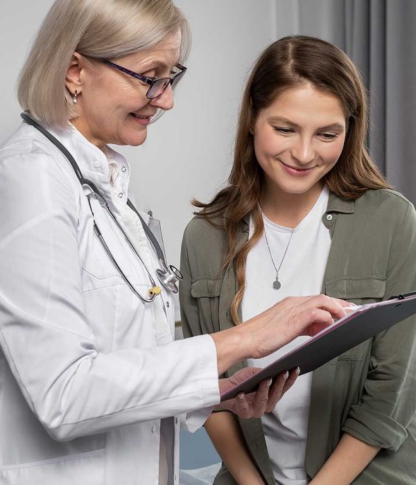 Picture of a female doctor with a woman reviewing visit summary